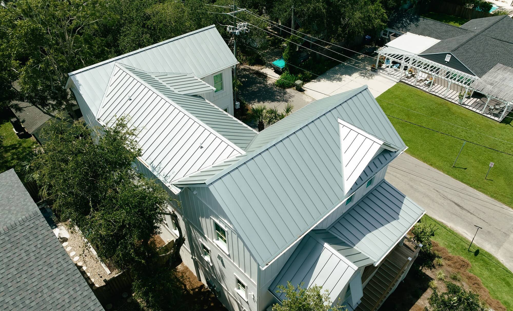 Grey standing seam metal roof on a coastal home