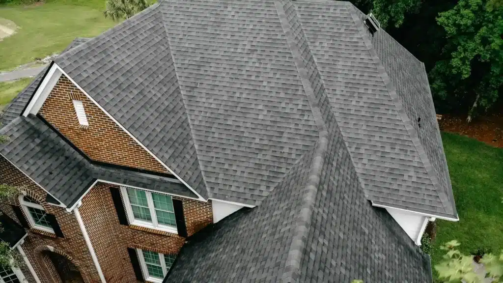 Grey asphalt shingle roof on a brick home