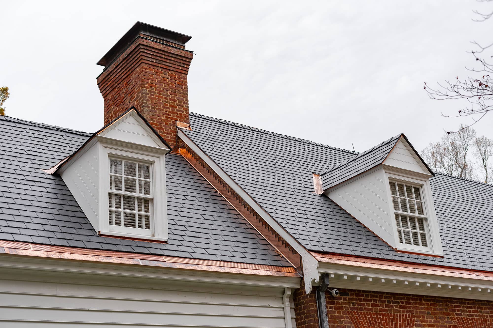 copper accents on black slate roof