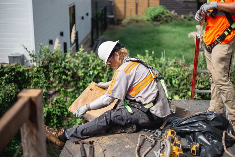 Roofer repairing roof boards