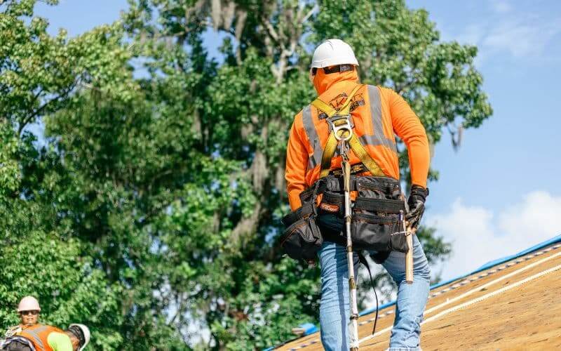 North Carolina roofer in safety assessing a shingle roof