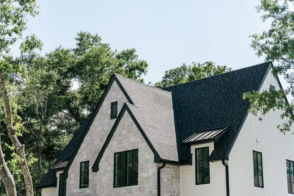 new steep black roof on grey stone home in Raleigh NC; example of best home improvement return on investment