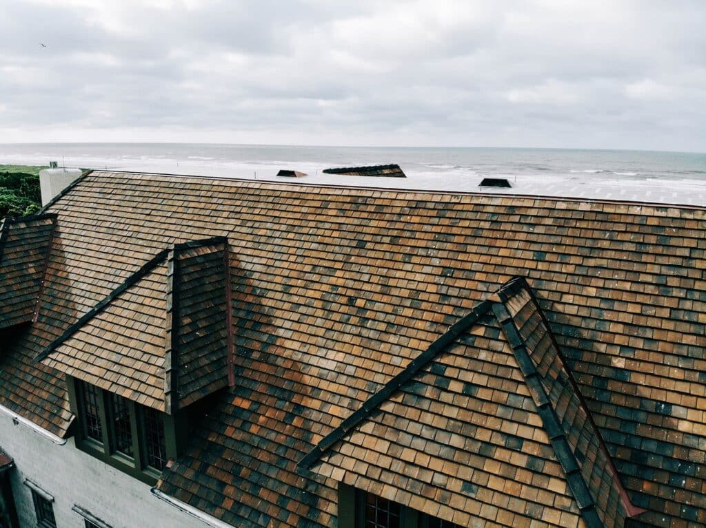 Clay tile roof with ocean in background