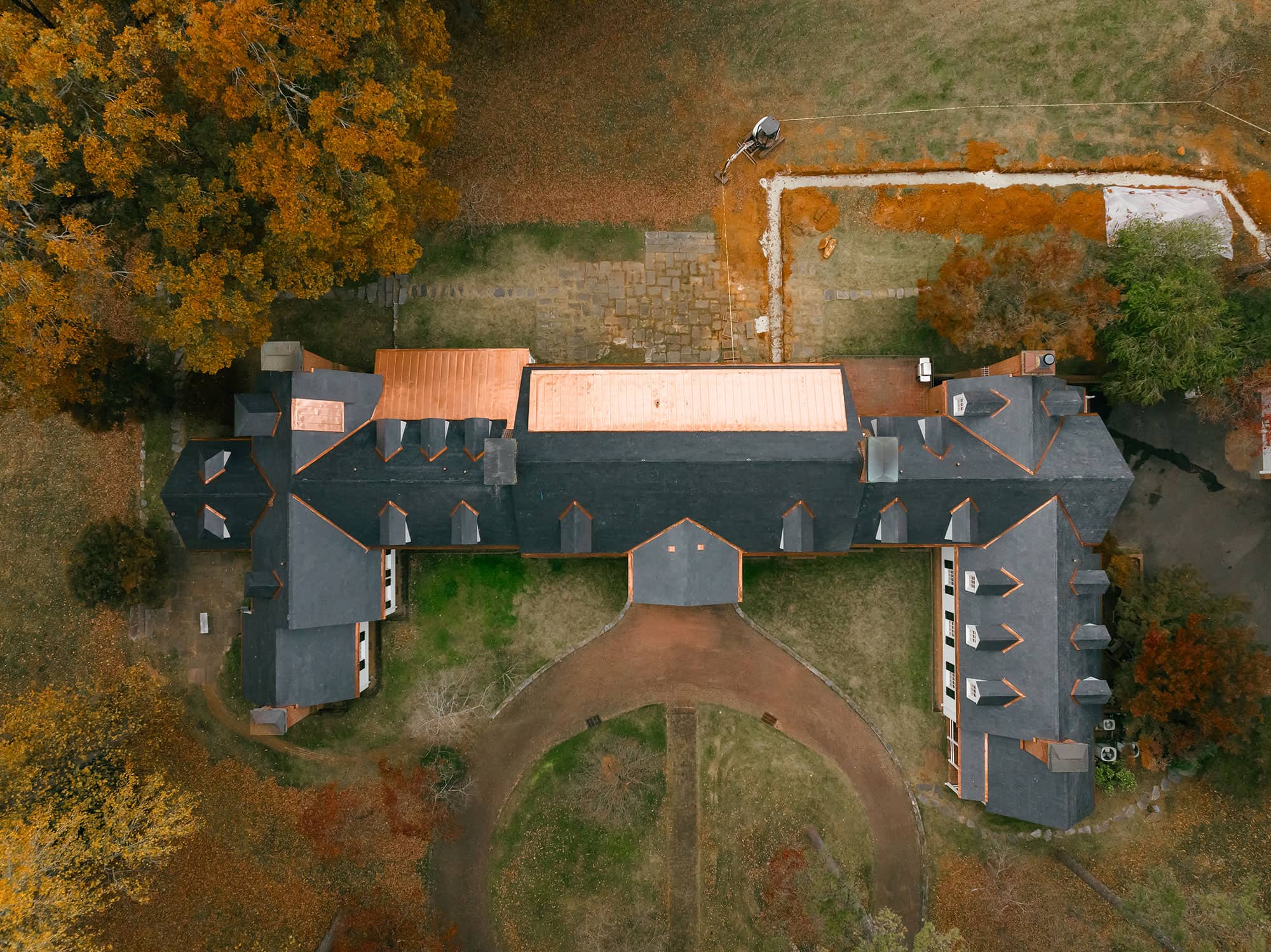Aerial of black slate roof on white farm home