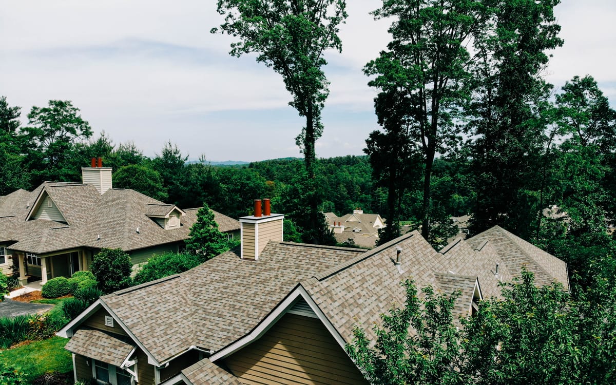 New shingle roofs on homes in a wooded mountain neighborhood
