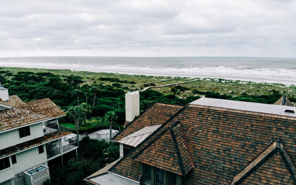 Cedar shake roof on an oceanfront Lowcountry home with the beach behind it