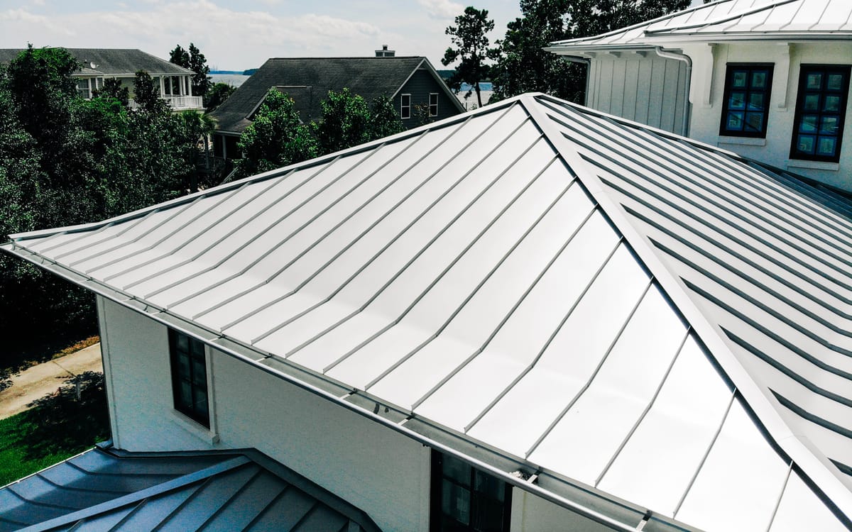 Standing-seam metal hip roof on a white Lowcountry home
