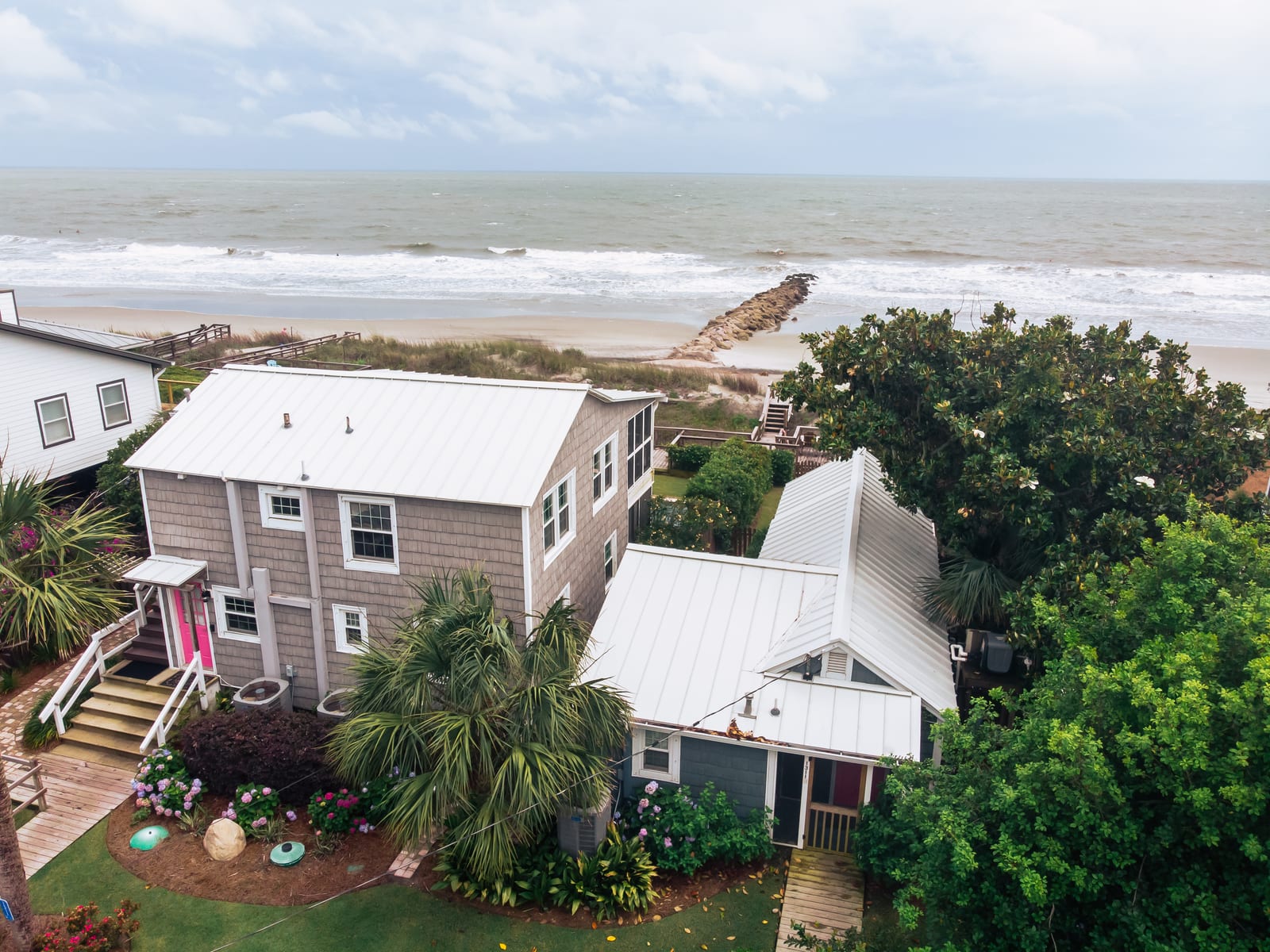 White metal roof on an oceanfront cottage steps from the beach