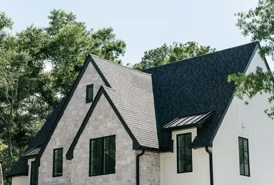 new steep black roof on grey stone home in Raleigh NC