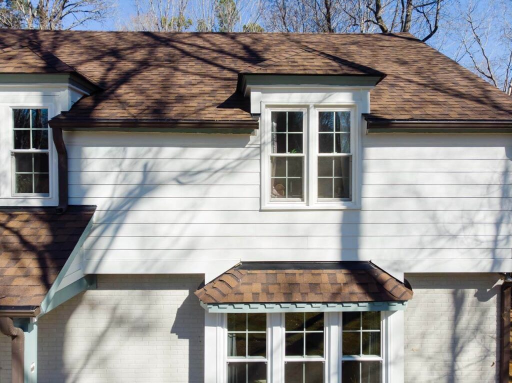 House with white siding and brown roof