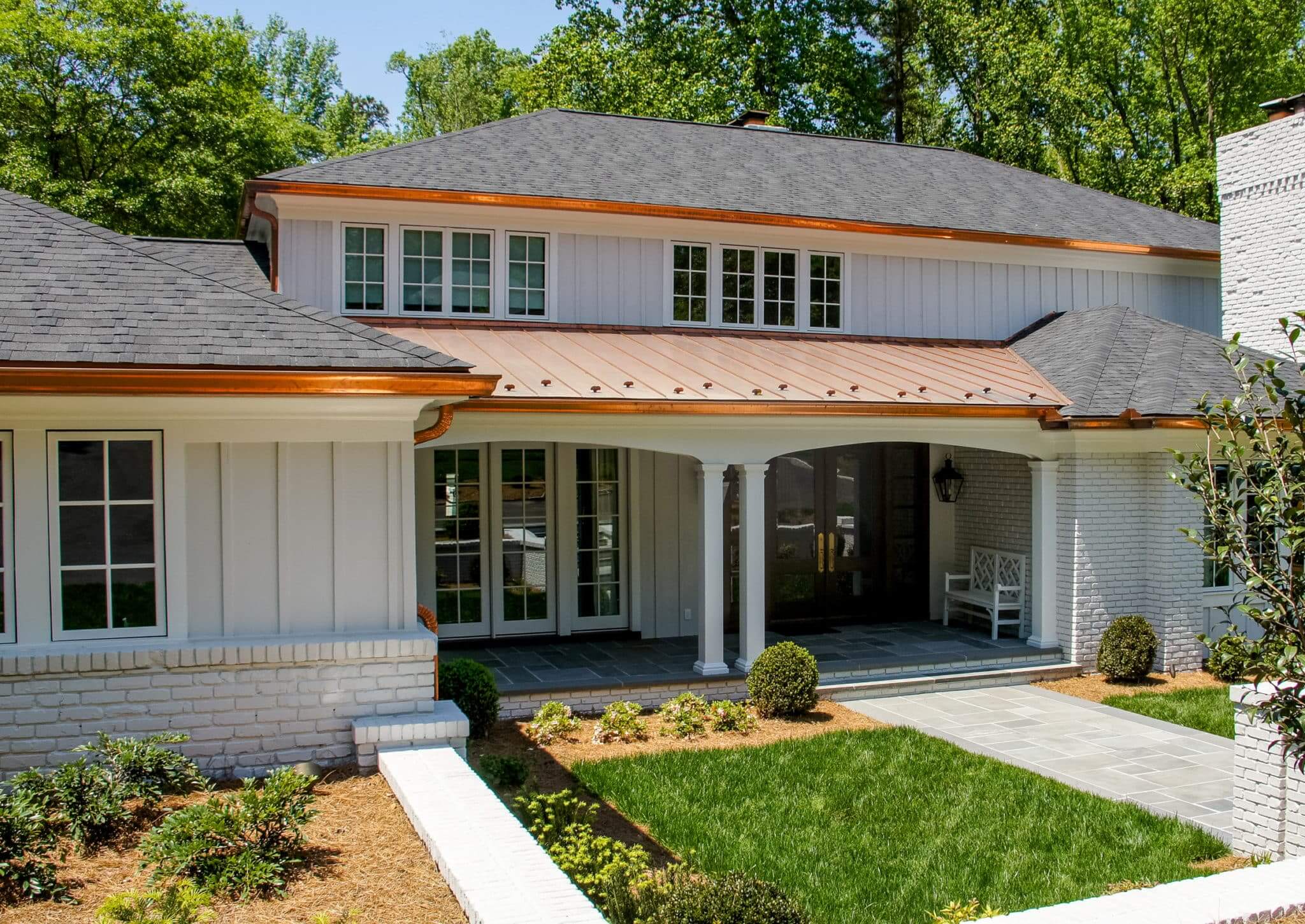 home with shingle roof and copper details on roof and copper gutters