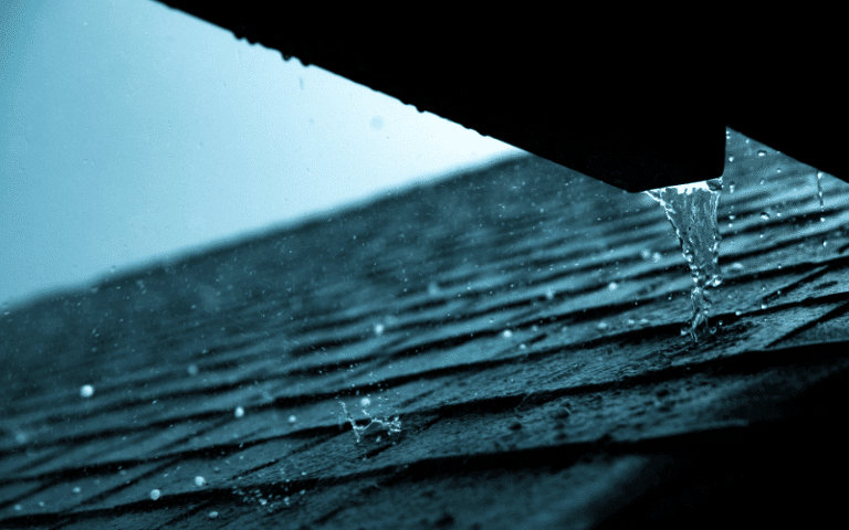 detailed photo close up of asphalt shingles with rain and hail falling