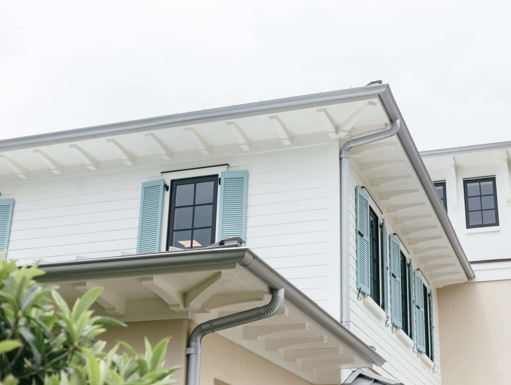 Grey gutters on white coastal home