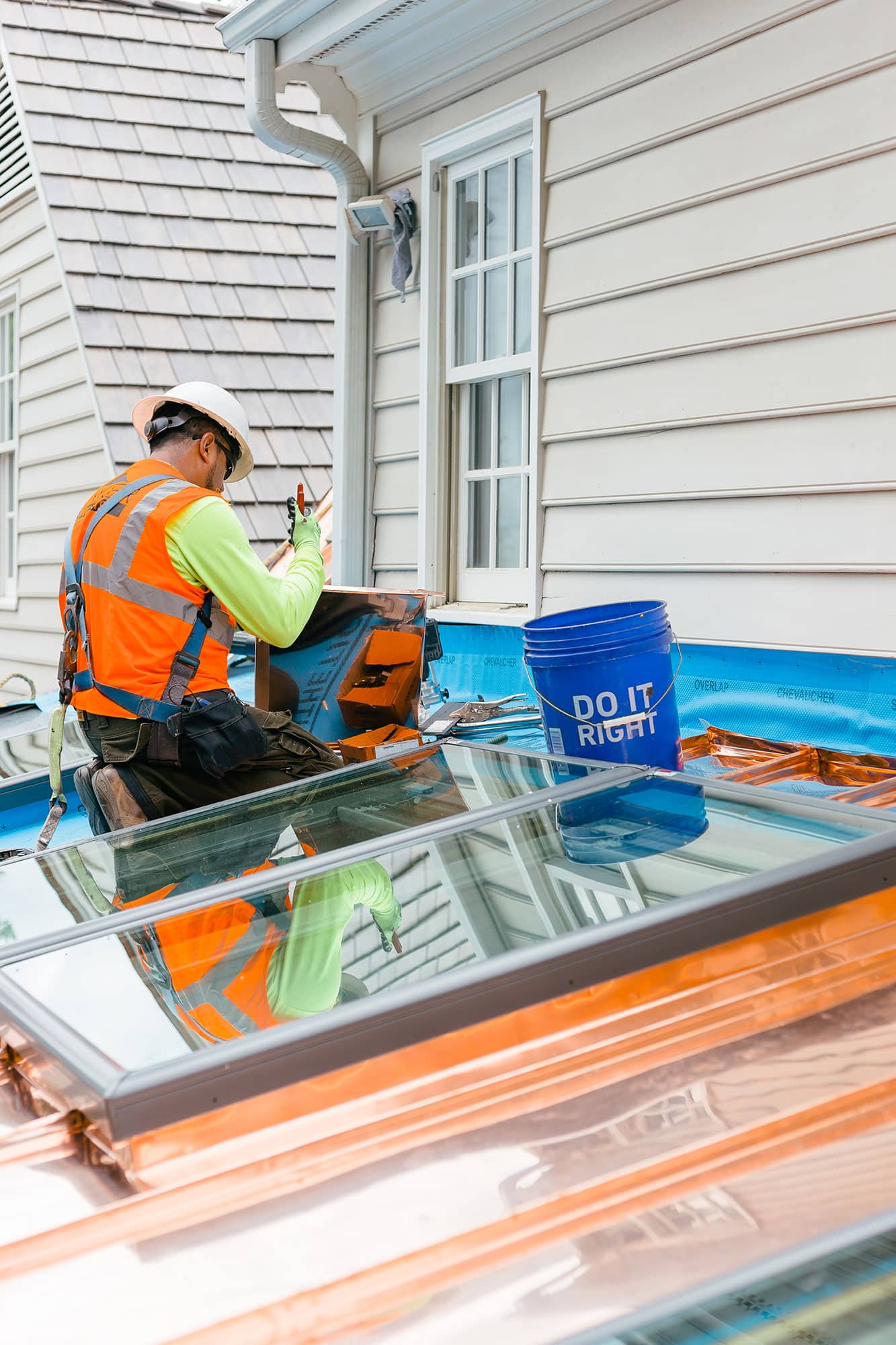 Roofer installing skylights on home