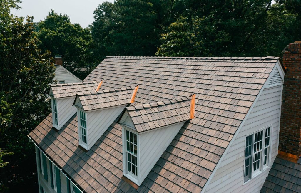 Brown synthetic roof shingles installed on white home