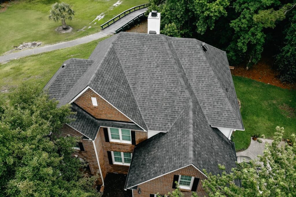 Aerial image of a grey shingle roof on brick home