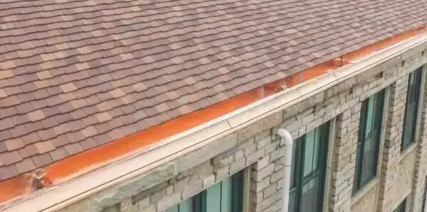 Copper Drip Edge on stone building. No copper roof patina has formed yet.