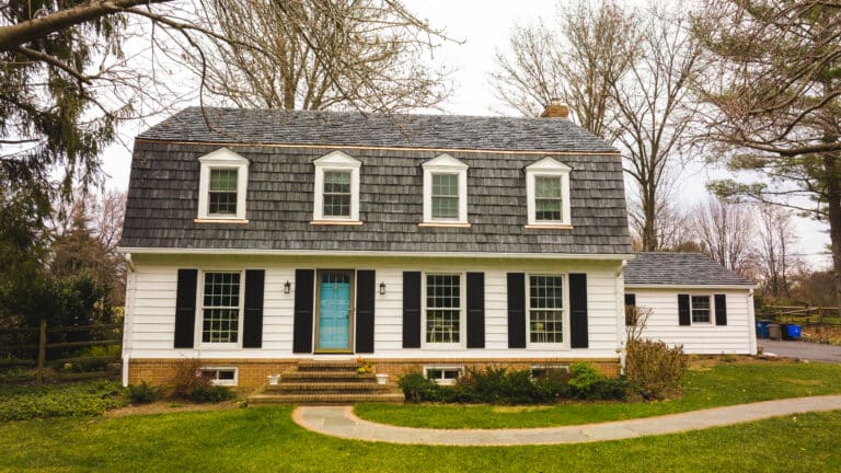 Cedar roof on white cottage home and blue door in Greensboro NC