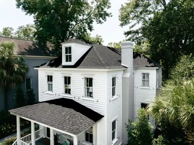 New white siding with window installation and shingle roof