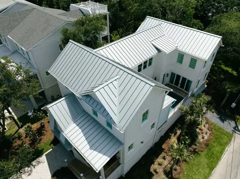 New metal roof installation on white coastal home