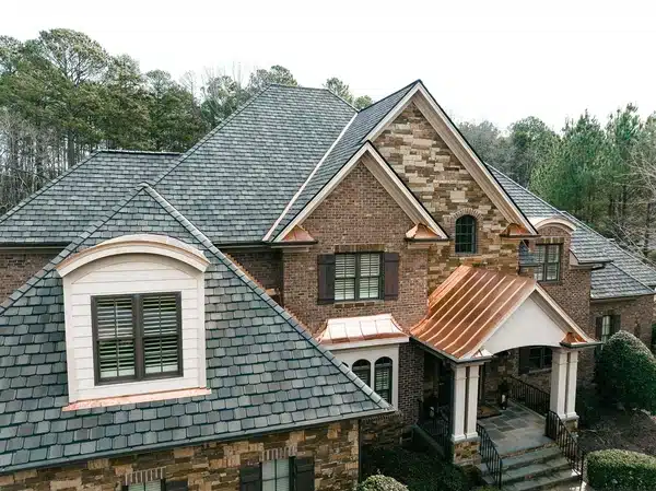 New shingle roof on brick home with copper accents